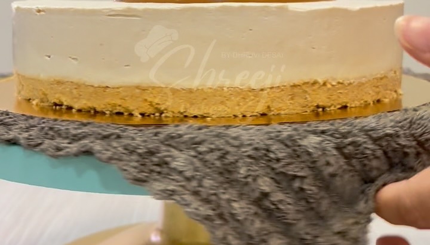 Cheesecake slice being lifted from the whole cake
